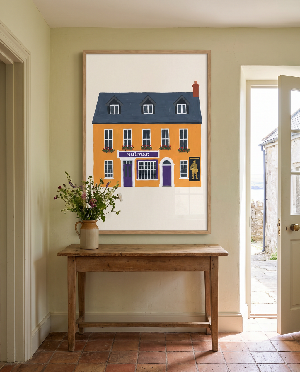 The Bulman print framed in oak, hanging in a bright Irish hallway above a timber console table