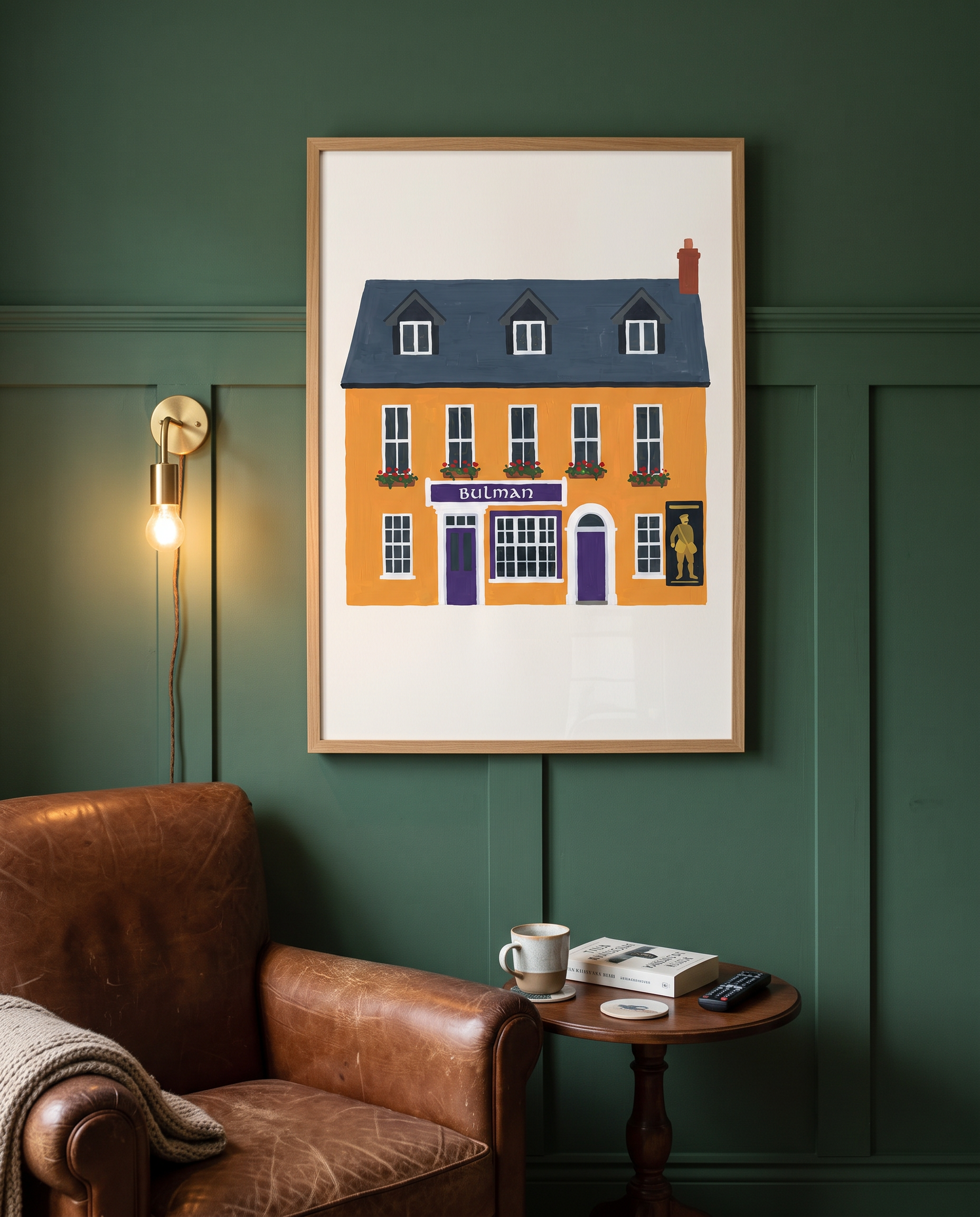 The Bulman print framed in oak on deep green panelling beside a leather armchair